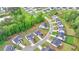 An aerial shot showcases new construction homes in a planned community with tree-lined streets and green spaces at 3180 Andover St, Cumming, GA 30028