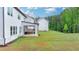Large backyard featuring a covered patio and ample green space at 3180 Andover St, Cumming, GA 30028