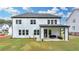 A beautiful two-story home with a well-maintained lawn and covered patio at 3180 Andover St, Cumming, GA 30028