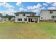 Large backyard with covered patio and view of surrounding trees at 3180 Andover St, Cumming, GA 30028