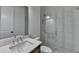 Modern bathroom featuring a sleek vanity, toilet, and glass-enclosed walk-in shower with marble tiling at 3180 Andover St, Cumming, GA 30028