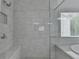 Elegant bathroom featuring a glass enclosed shower and a soaking tub with marble tiling at 3180 Andover St, Cumming, GA 30028