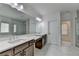 Well-lit bathroom with double sinks, a large mirror, and a glass-enclosed shower at 3180 Andover St, Cumming, GA 30028