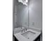 Well-lit half bathroom offers a sleek mirror and vanity with a sink and chrome faucet at 3180 Andover St, Cumming, GA 30028