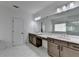Modern bathroom with double sinks and vanities, a large mirror, and tile flooring at 3180 Andover St, Cumming, GA 30028