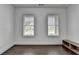 Bright bedroom features hardwood floors and two windows overlooking the backyard at 3180 Andover St, Cumming, GA 30028
