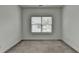 Neutral bedroom featuring gray carpet and a large window providing natural light at 3180 Andover St, Cumming, GA 30028
