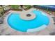 Aerial shot shows a community pool with a central island, lounge chairs, and a surrounding sun deck at 3180 Andover St, Cumming, GA 30028