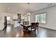 Dining room with hardwood floors, a modern chandelier, and views of the landscaped yard at 3180 Andover St, Cumming, GA 30028