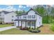 Charming two-story home featuring a well-manicured front yard and a covered porch at 3180 Andover St, Cumming, GA 30028