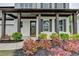 Charming front porch with dark wood columns and trim, surrounded by a beautifully landscaped garden at 3180 Andover St, Cumming, GA 30028
