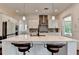Kitchen featuring a large island with seating, modern appliances, and white cabinets at 3180 Andover St, Cumming, GA 30028