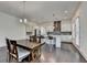 Kitchen featuring hardwood floors, stainless steel appliances, a center island, and a view into the living room at 3180 Andover St, Cumming, GA 30028