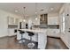 Bright kitchen with a large center island, pendant lighting, stainless steel appliances, and dark hardwood floors at 3180 Andover St, Cumming, GA 30028