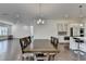 Kitchen and dining area featuring hardwood floors, stainless steel appliances, a center island, and ample counter space at 3180 Andover St, Cumming, GA 30028