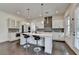 Bright kitchen with a large center island, pendant lighting, stainless steel appliances, and dark hardwood floors at 3180 Andover St, Cumming, GA 30028