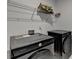Modern laundry room featuring new front loading washer and dryer with shelving above at 3180 Andover St, Cumming, GA 30028