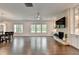 Bright, spacious living room with hardwood floors, many windows, and stone fireplace wall with TV at 3180 Andover St, Cumming, GA 30028