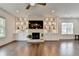 Spacious living room featuring a fireplace with built-in shelving and dark hardwood floors at 3180 Andover St, Cumming, GA 30028