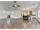 Open concept living area with hardwood floors, a kitchen, a dining area, and natural lighting at 3180 Andover St, Cumming, GA 30028