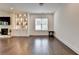 Open-concept living room boasts hardwood floors, a custom fireplace, and lots of natural light at 3180 Andover St, Cumming, GA 30028