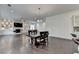 Spacious living room featuring dark hardwood floors, fireplace, built-in shelving, and a large dining table at 3180 Andover St, Cumming, GA 30028