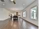 Open concept living area with hardwood floors, and windows providing natural lighting at 3180 Andover St, Cumming, GA 30028