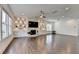 Bright living room with a stone fireplace, built-in shelves, hardwood floors, and natural light at 3180 Andover St, Cumming, GA 30028
