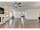 Large living area with hardwood floors, a stone fireplace, built-in shelves, and recessed lighting at 3180 Andover St, Cumming, GA 30028