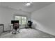 Home office featuring carpeted floors and bright window allowing ample natural light at 3180 Andover St, Cumming, GA 30028