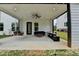 Covered patio with a ceiling fan and outdoor seating overlooking the backyard at 3180 Andover St, Cumming, GA 30028