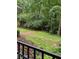 Large backyard with mature trees and greenery, partially enclosed by a wooden fence at 3876 Winners Ct, Marietta, GA 30062