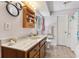 Bathroom featuring a vanity with marble top, wood cabinets, and unique mirrors at 3876 Winners Ct, Marietta, GA 30062