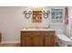 Bathroom with light purple walls, Mickey Mouse mirrors, and a wood vanity at 3876 Winners Ct, Marietta, GA 30062