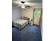 Cozy bedroom featuring neutral walls, blue carpet, and ceiling fan with overhead lighting at 3876 Winners Ct, Marietta, GA 30062