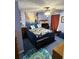 Comfortable bedroom featuring blue walls, patterned bedding, and a ceiling fan with light fixture at 3876 Winners Ct, Marietta, GA 30062