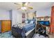 Blue bedroom featuring a bed, a desk with computers, a ceiling fan, and a closet at 3876 Winners Ct, Marietta, GA 30062