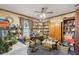 Cluttered room with ceiling fan, bookshelves, boxes, and vintage decor at 3876 Winners Ct, Marietta, GA 30062