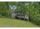 Two-story house with a white balcony, surrounded by lush green trees and vegetation at 3876 Winners Ct, Marietta, GA 30062