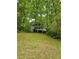Two-story home with a gray exterior featuring double porches framed by mature trees and lawn at 3876 Winners Ct, Marietta, GA 30062