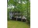 Two-story home with a gray exterior featuring double porches framed by mature trees at 3876 Winners Ct, Marietta, GA 30062