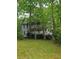 Two-story home nestled among mature trees with a large porch at 3876 Winners Ct, Marietta, GA 30062