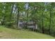 Two-story house with a white balcony, surrounded by lush green trees and vegetation at 3876 Winners Ct, Marietta, GA 30062