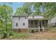 Charming home featuring a screened-in porch and picturesque surroundings with mature trees at 3876 Winners Ct, Marietta, GA 30062