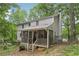 Exterior view showcasing the home's screened porch, siding, and mature trees at 3876 Winners Ct, Marietta, GA 30062