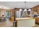 Warm kitchen with wooden cabinets, stainless steel appliances, island, and adjacent dining area at 3876 Winners Ct, Marietta, GA 30062