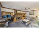 Comfortable living room featuring a brick fireplace, workspace, and a ceiling fan at 3876 Winners Ct, Marietta, GA 30062