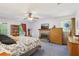 Bright main bedroom featuring a fireplace, ceiling fan and a door leading to the exterior at 3876 Winners Ct, Marietta, GA 30062