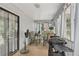 Cozy screened porch with furnishings, grill and natural light streaming through the screened walls at 3876 Winners Ct, Marietta, GA 30062