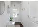 Bright entryway featuring white walls, coat hooks, and a decorative mirror at , Atlanta, GA 30316